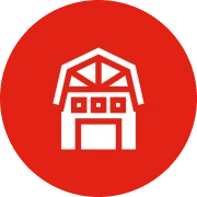 White barn icon on red circle background.